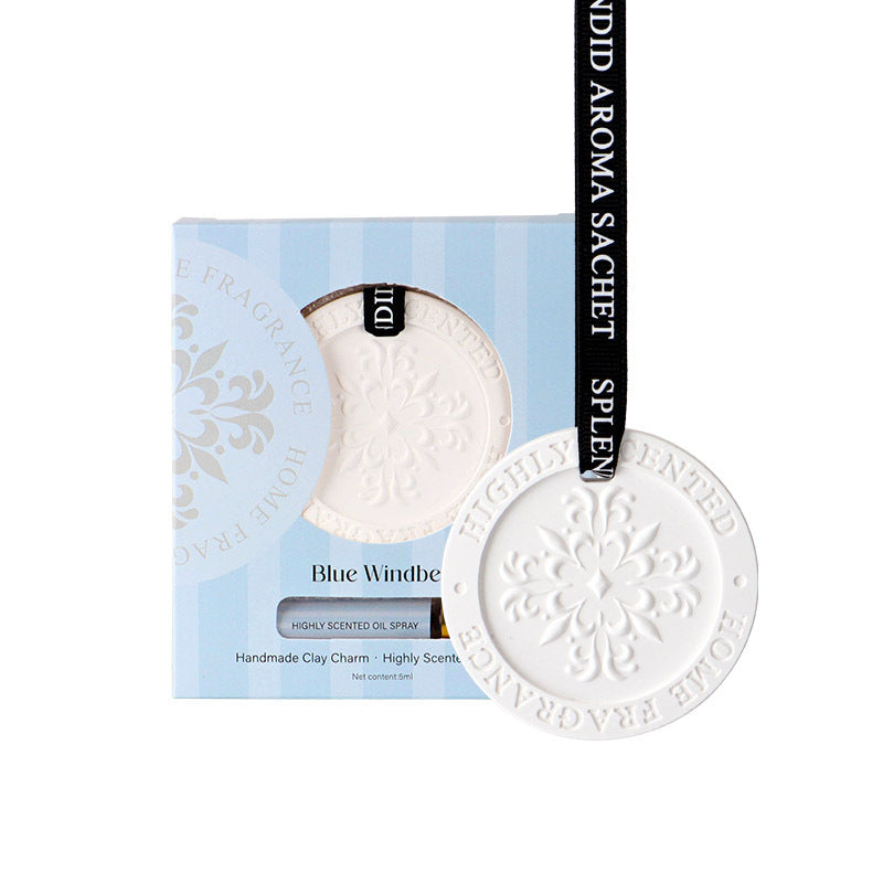 White ceramic charm with 'Blue Windbe' text on a blue and white box