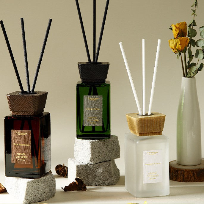 Three diffusers with sticks on a neutral background