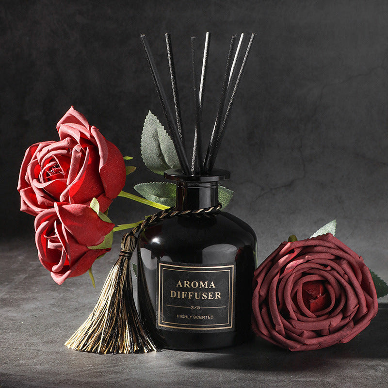 Black aroma diffuser with decorative roses on a dark background