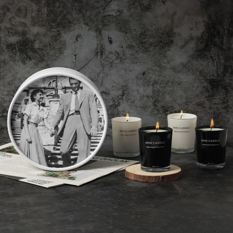 Candles with a vintage photo of a couple on a dark surface
