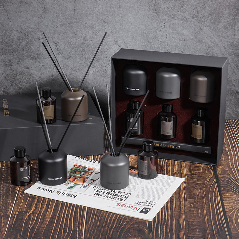 Aromatherapy diffuser set with bottles and packaging on a wooden surface.