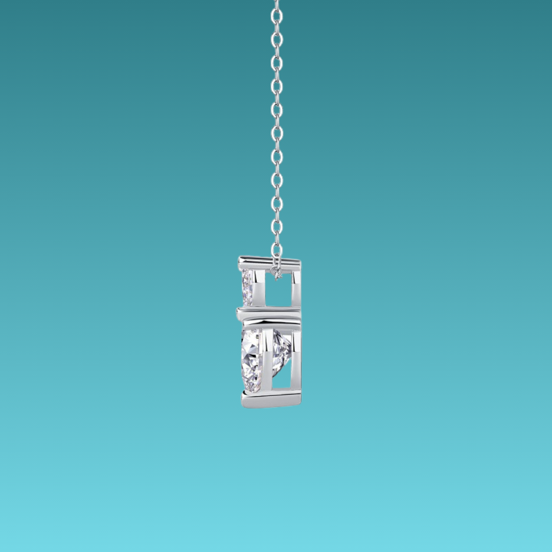 Silver pendant with chain on a teal background