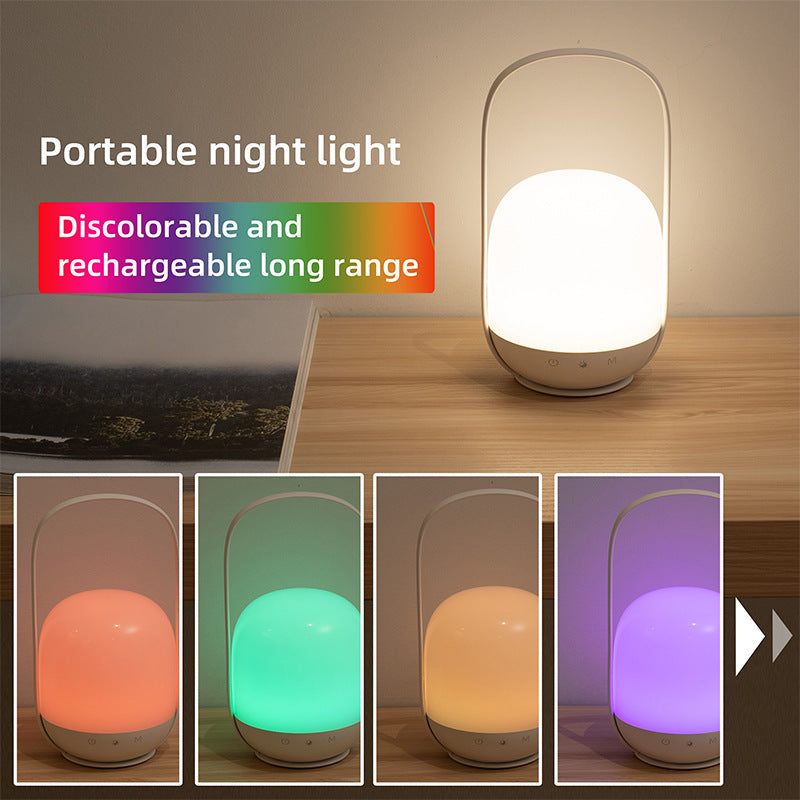 Portable night light with color-changing capabilities on a wooden surface.