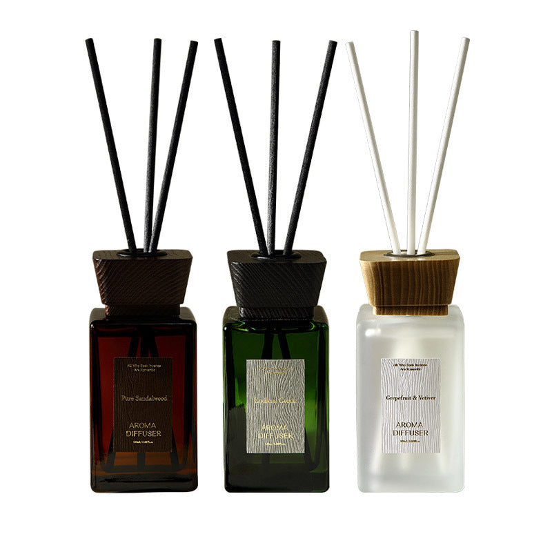 Three diffusers with sticks on a white background