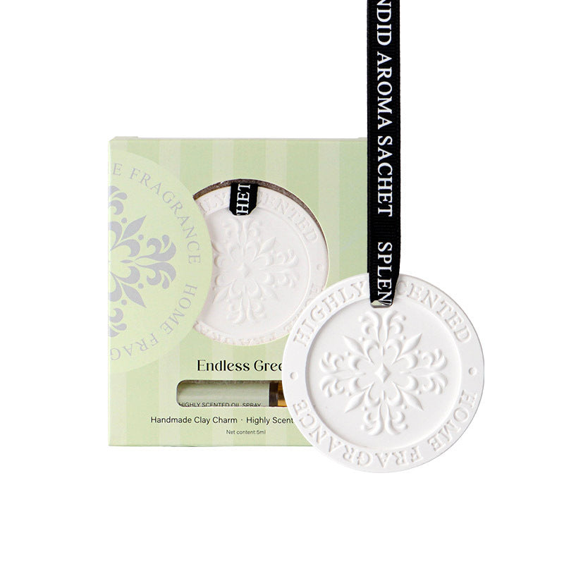 White ceramic charm with 'Endless Green' text on a green packaging background