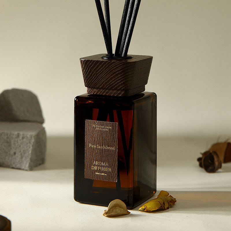 Aroma diffuser with wooden base and label on a neutral background