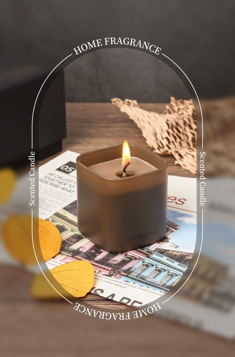 Scented candle burning on a newspaper with 'Home Fragrance' text overlay.