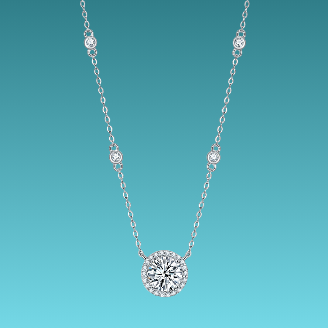 Silver necklace with a round diamond pendant on a teal background