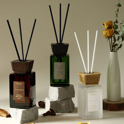 Collection of diffusers with sticks on a neutral background