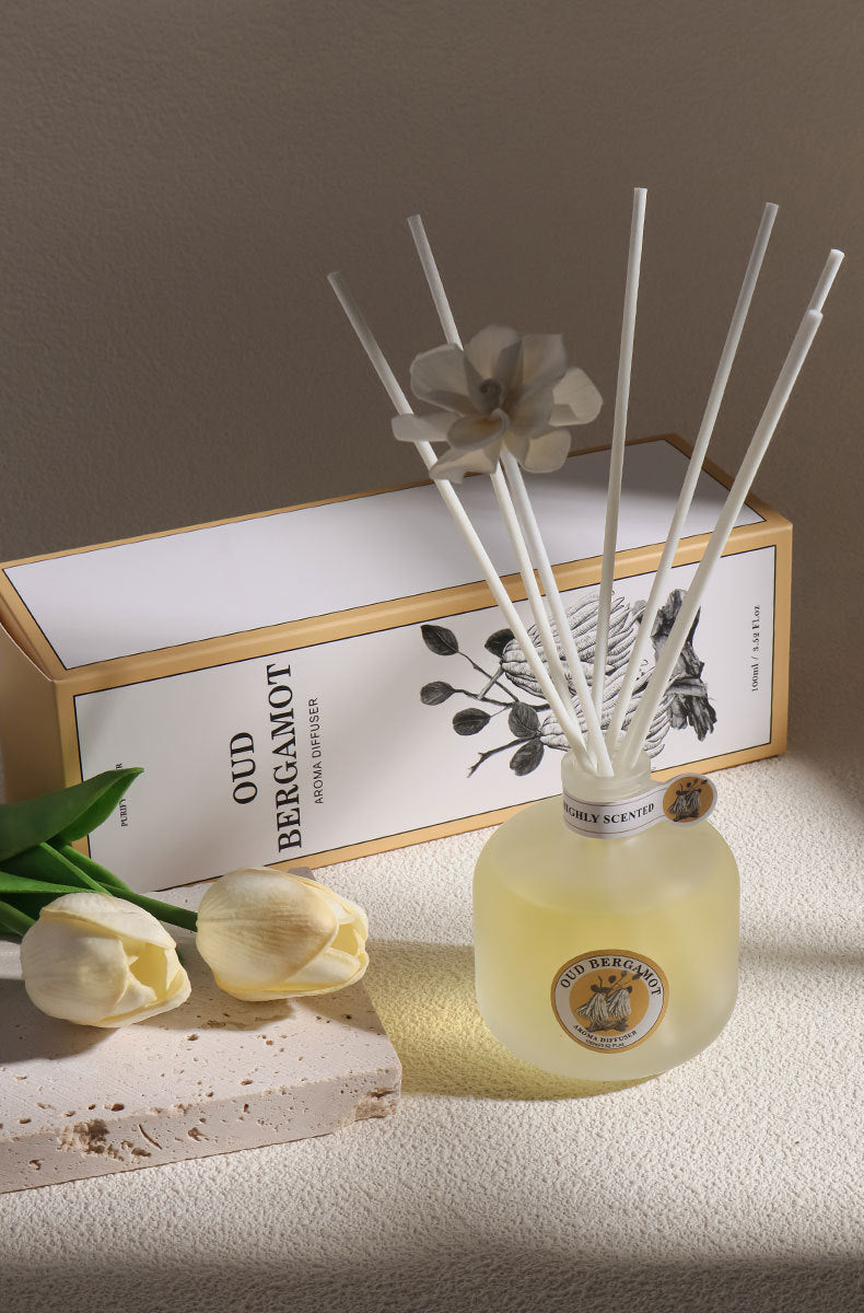 Decorative diffuser with sticks on a light surface, with a blurred background