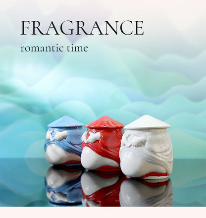 Three ceramic containers with lids on a reflective surface, labeled 'FRAGRANCE romantic time' on a blurred background.
