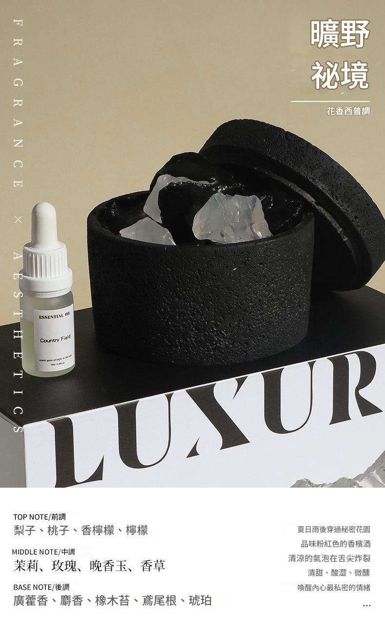 Black container with crystals, dropper bottle, and 'LUXUR' text on a beige background