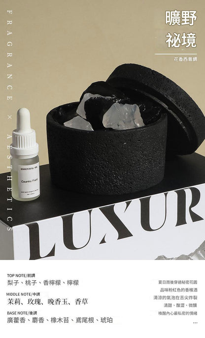 Black container with crystals, dropper bottle, and 'LUXUR' text on a beige background