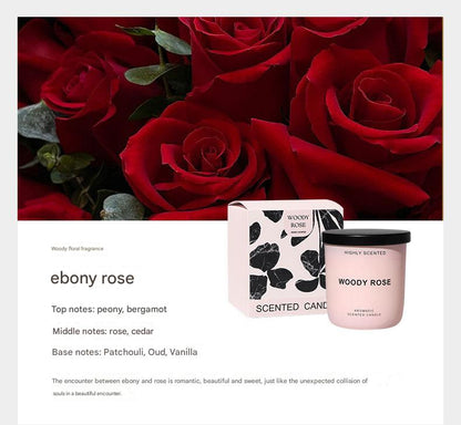 Woody Rose scented candle with packaging against a background of red roses