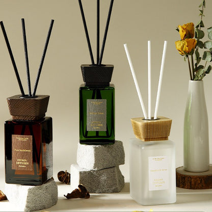 Three diffusers with sticks on a neutral background