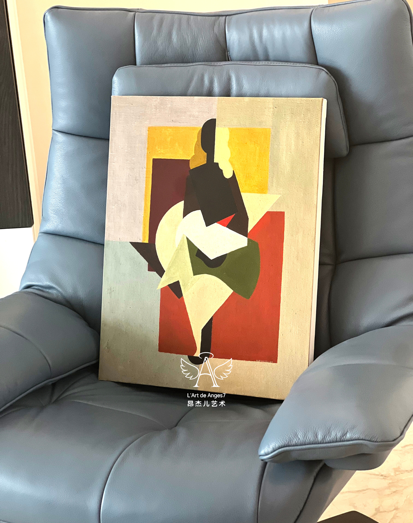 Abstract art piece on a gray leather chair