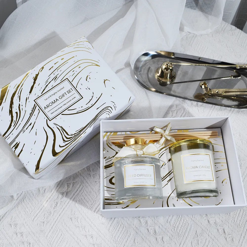 Aroma gift set with candles and diffuser on a white surface
