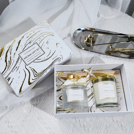 Aroma gift set with candles and diffuser on a white surface