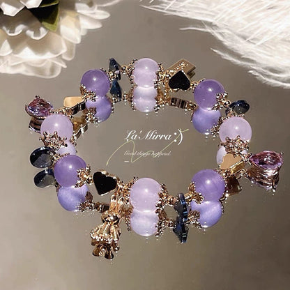 Bracelet with purple and gold charms on a soft background