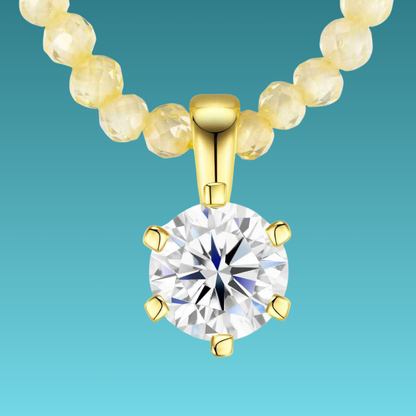 Gold necklace with a diamond pendant on a teal background
