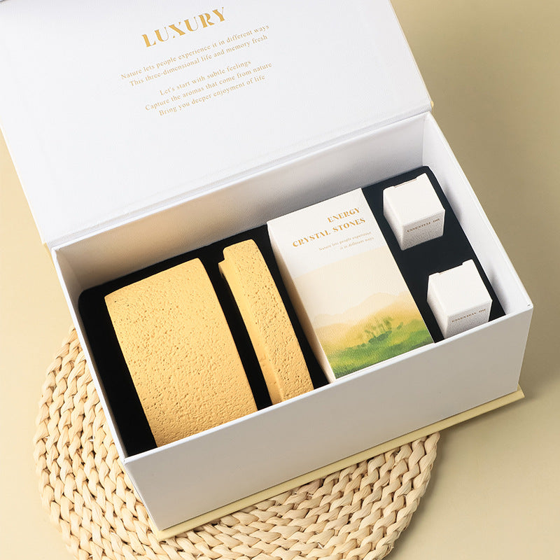 Luxury product set in a white box on a beige surface
