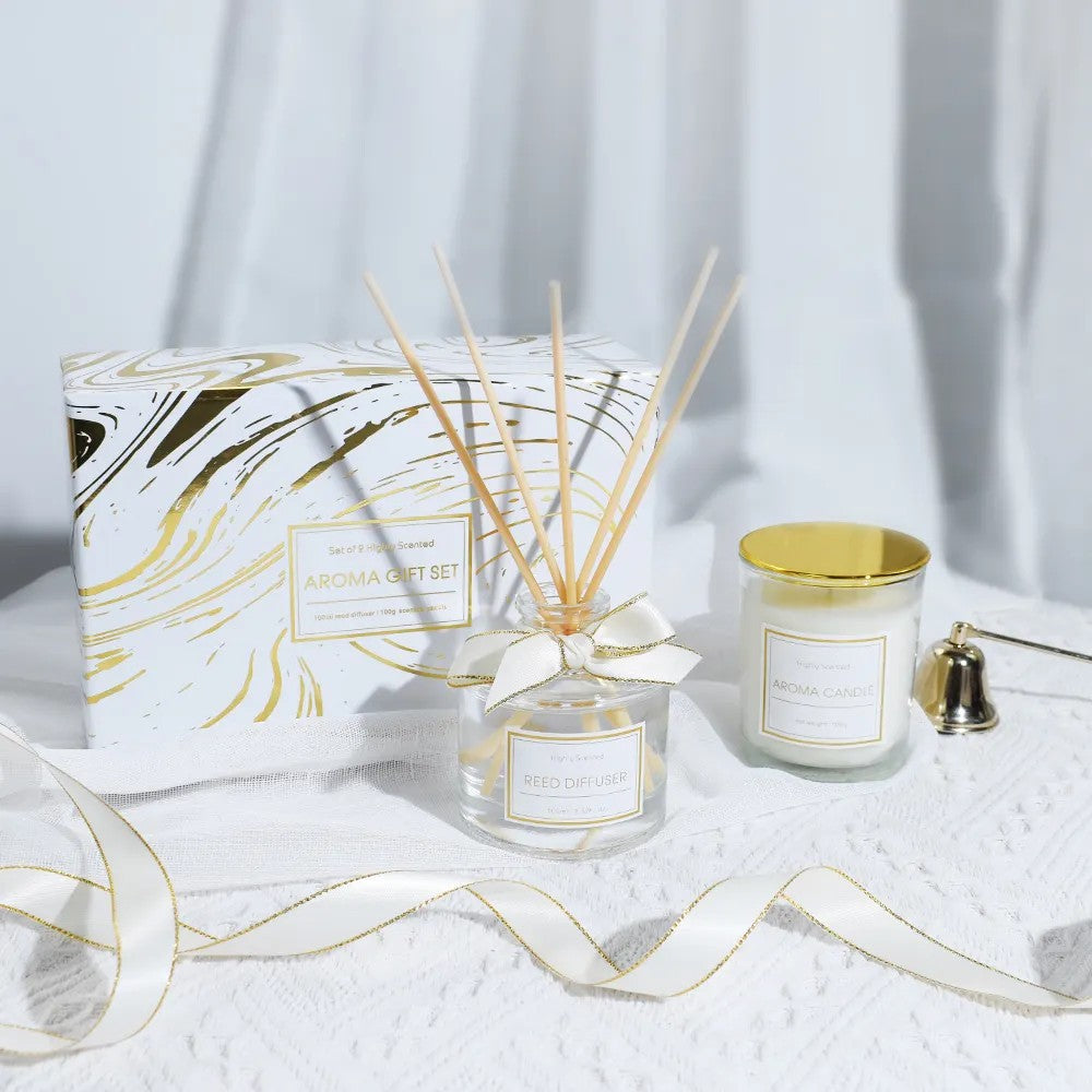 Aromatherapy gift set with a candle, diffuser, and packaging on a white surface.