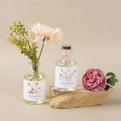 Reed diffuser with floral elements on a beige background