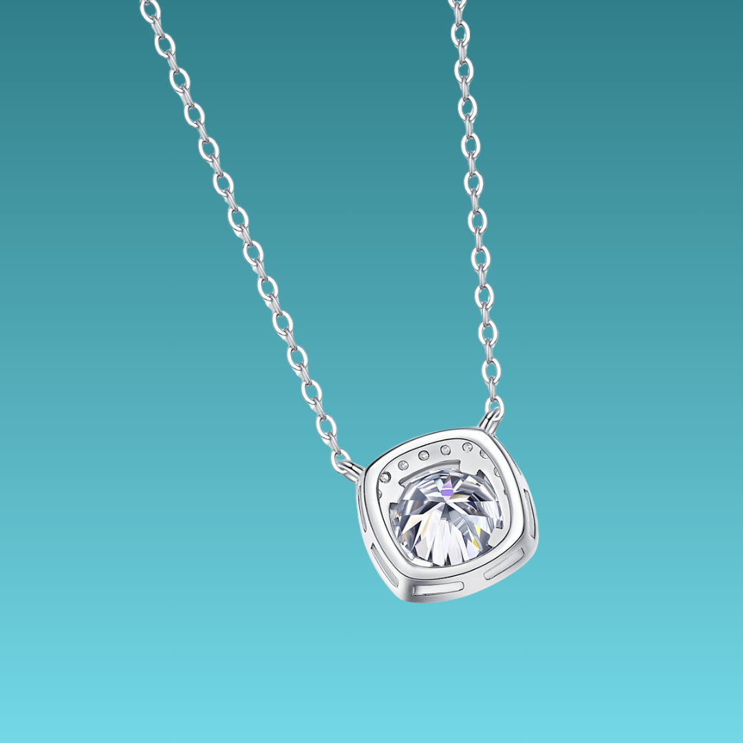 Silver necklace with a diamond pendant on a teal background