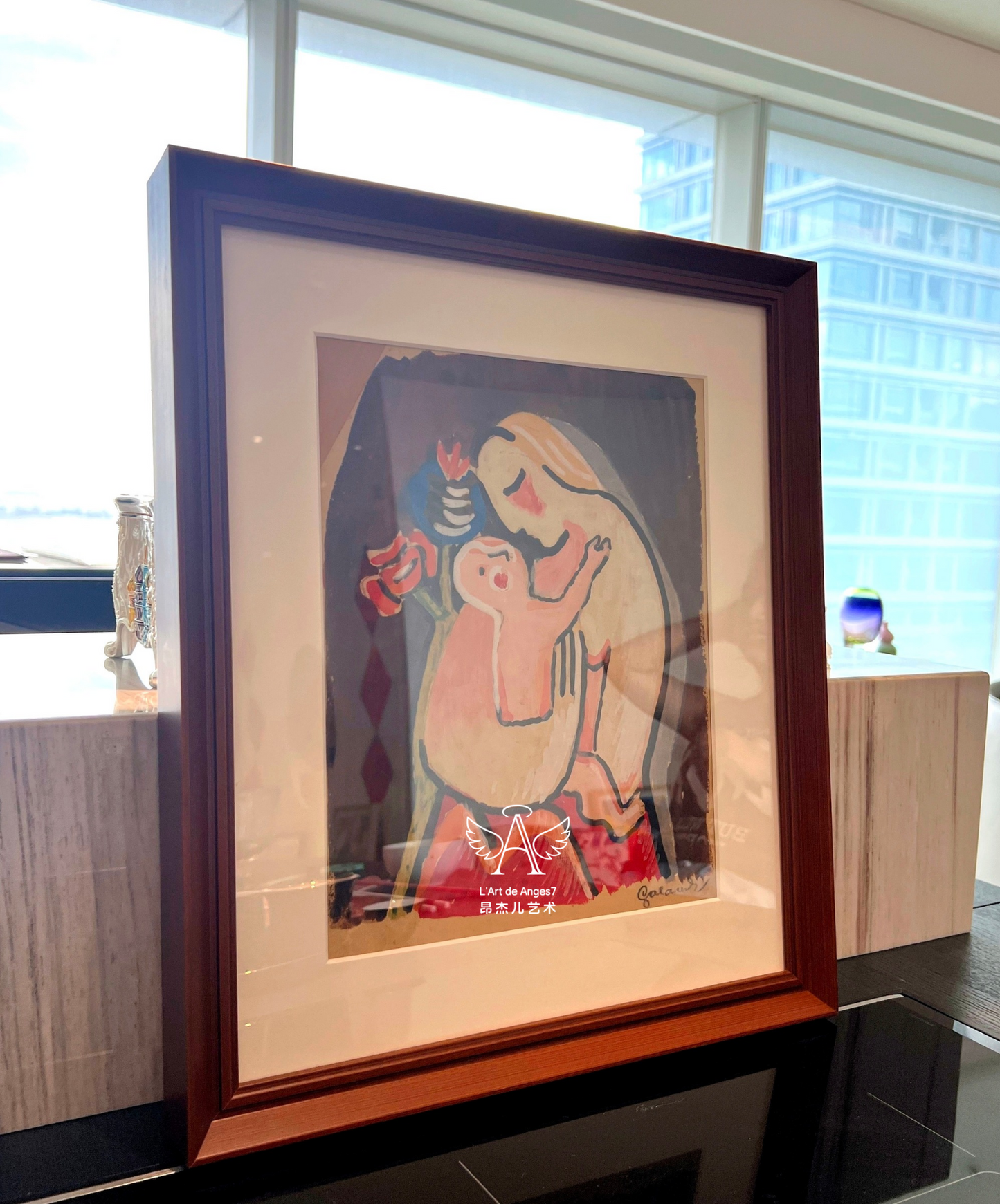 Framed artwork of a stylized figure with abstract elements on a reflective surface.