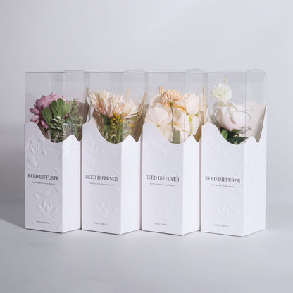 Four white boxes labeled 'Reed Diffuser' containing floral arrangements on a light gray background.