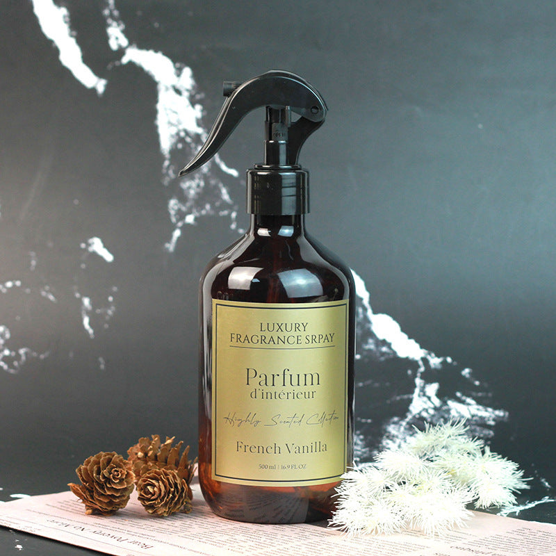 Luxury fragrance spray bottle labeled 'Parfum d'intérieur' with decorative elements on a dark background