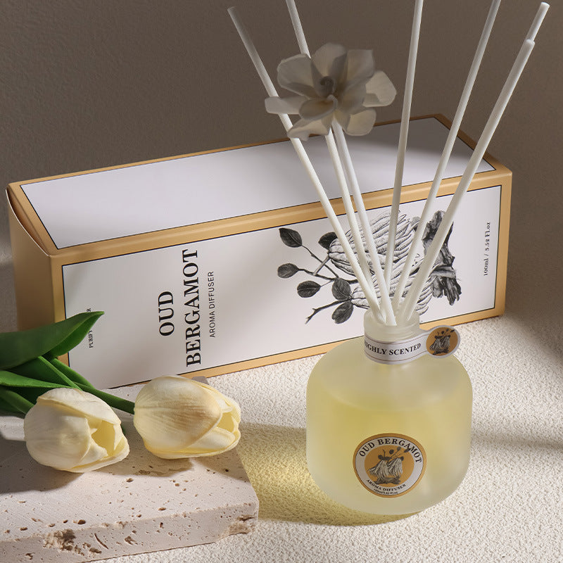 Aromatherapy diffuser with floral packaging on a neutral background