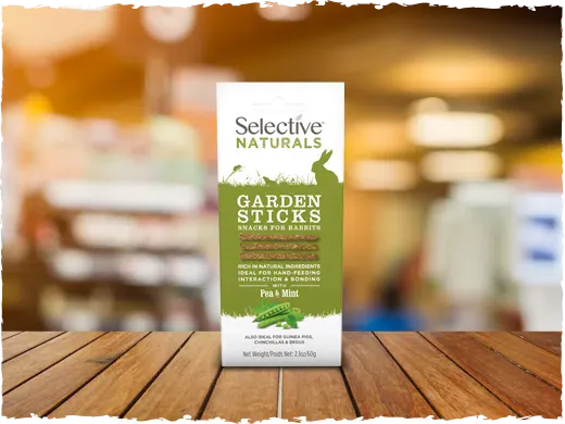 Selective Naturals Garden Sticks package on a wooden surface with a blurred background