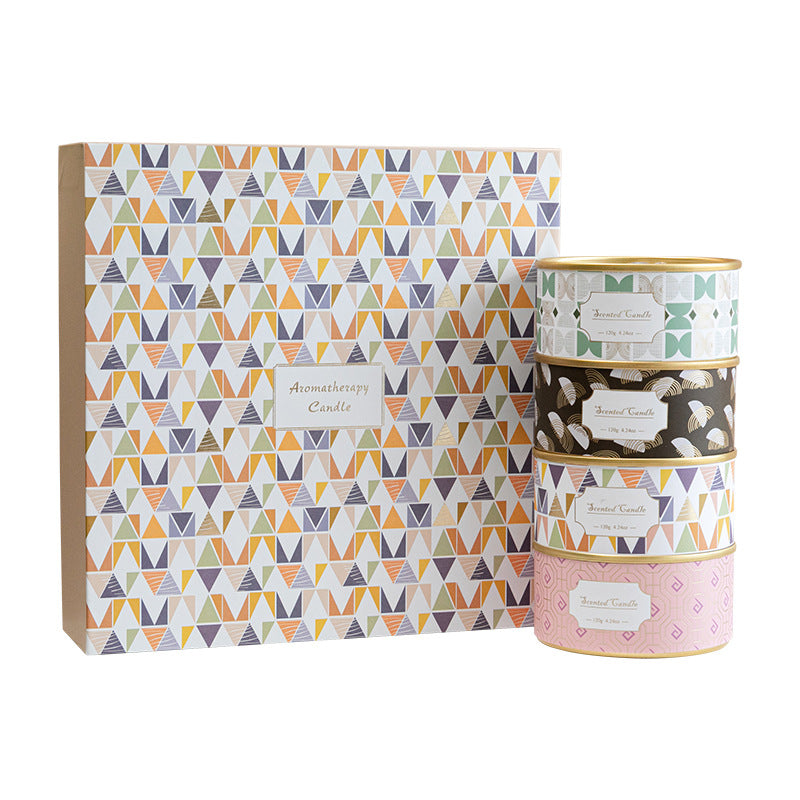 Set of three patterned candles with a matching box on a white background