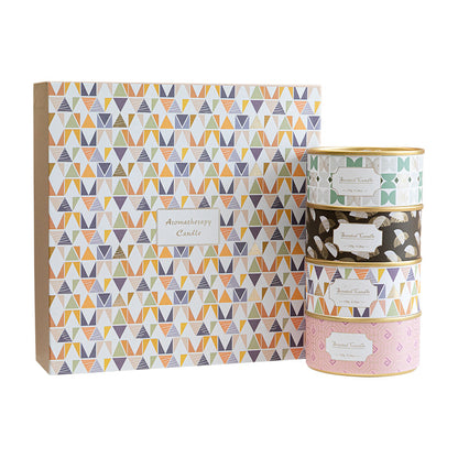 Set of three patterned candles with a matching box on a white background