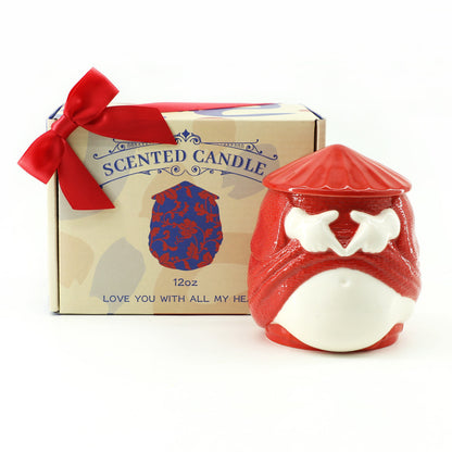 Red and white scented candle with a decorative box on a white background