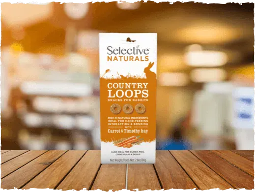 Selective Naturals Country Loops snack package on a wooden surface with a blurred background