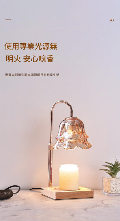 Table lamp with a glass shade on a wooden base next to a candle and plant, with text in Chinese.