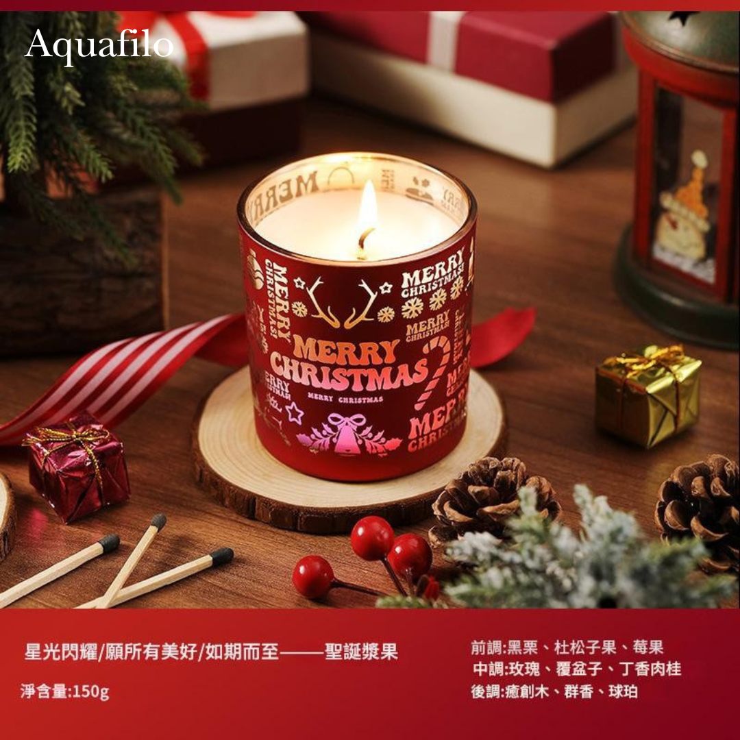 Decorative Christmas candle with festive design on a wooden surface with matches and small gifts.