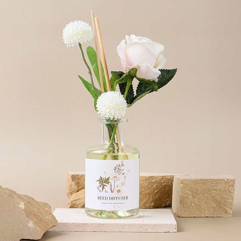 Reed diffuser with flowers on a neutral background