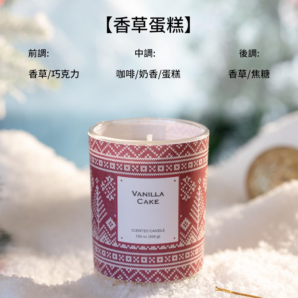 Scented candle labeled 'Vanilla Cake' with a pattern on a snowy background