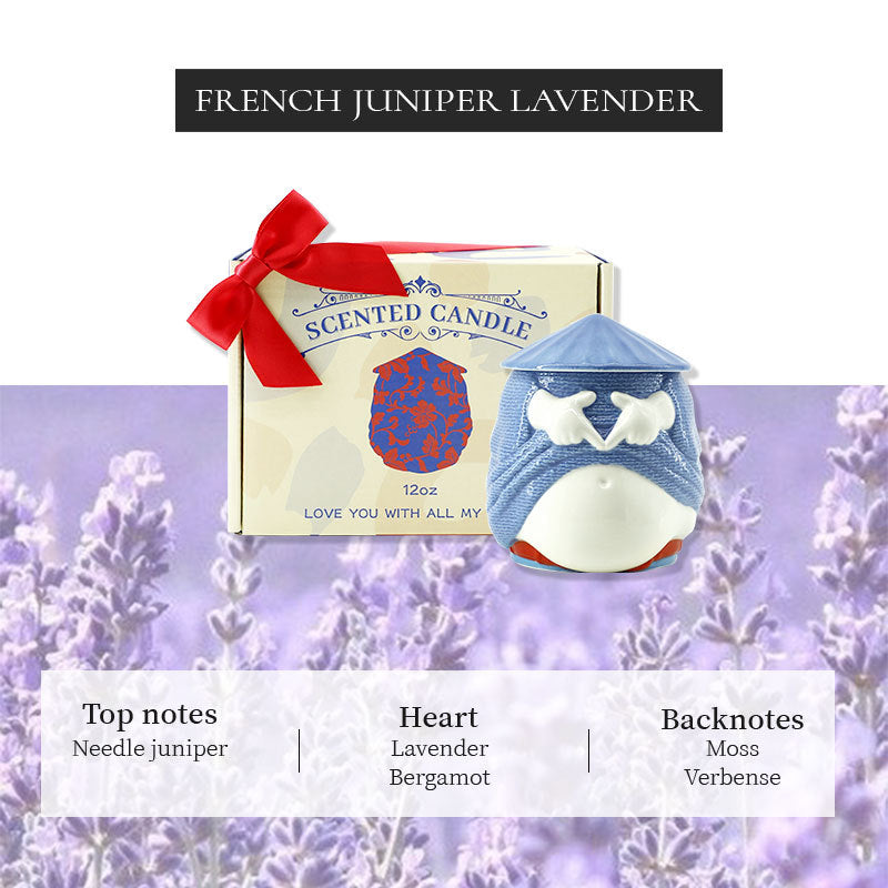 Scented candle with packaging and lavender flowers in the background