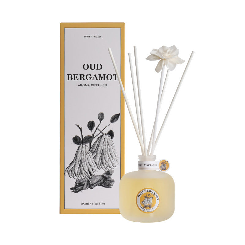 Aroma diffuser with reeds and packaging on a white background