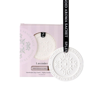 White clay charm with 'Fragrance House' branding on a pink packaging background.