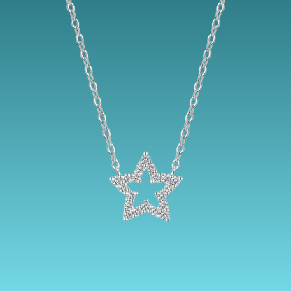 Star-shaped silver necklace on a turquoise background