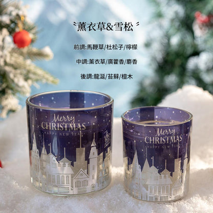 Two Christmas-themed candle holders with a snowy village design on a white surface.