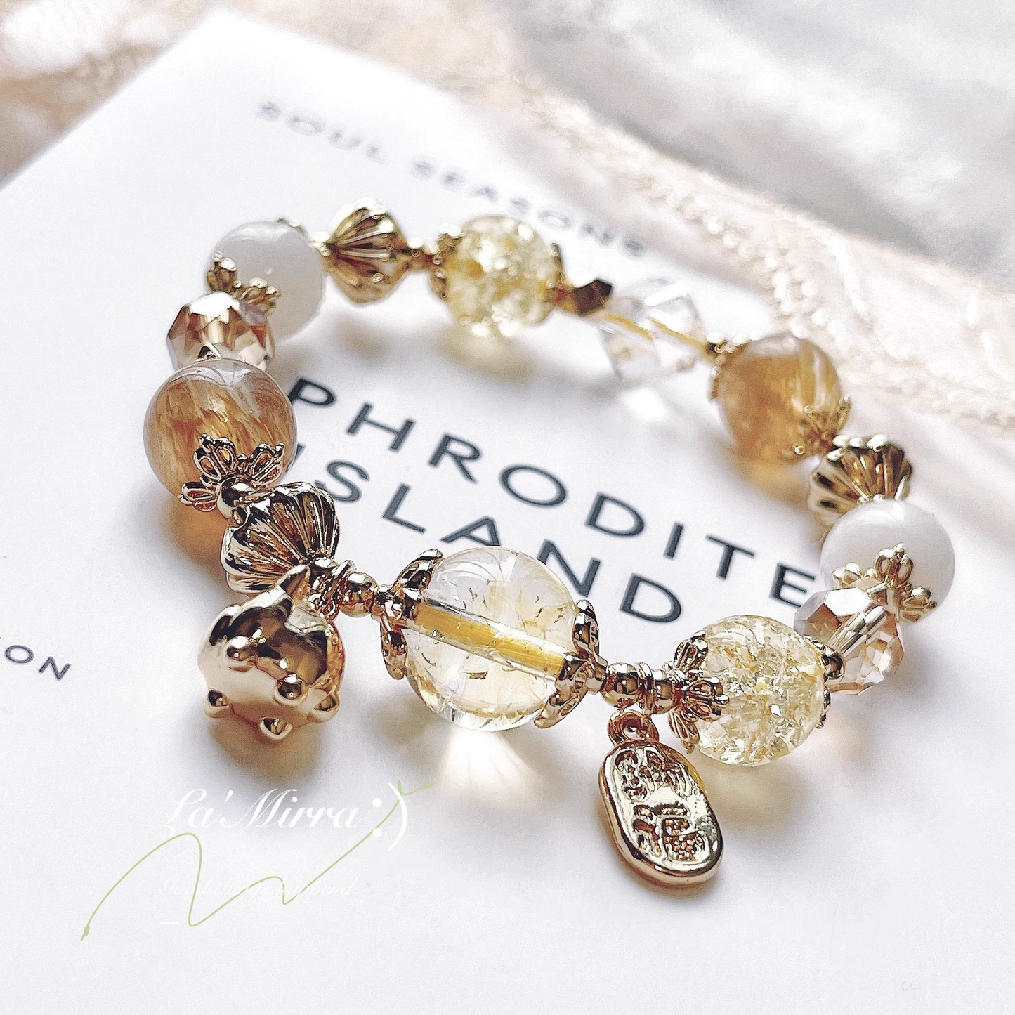 Bracelet with gold and clear beads on a white surface
