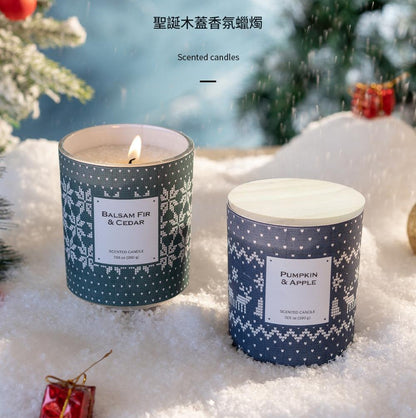Two scented candles with festive labels on a snowy background