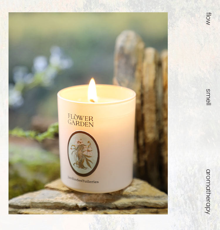 Floral-scented candle labeled 'Flower Garden' on a stone surface with a natural background.