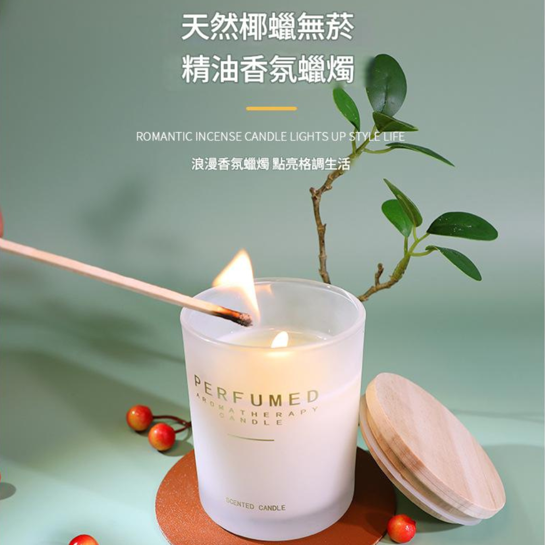 Perfumed candle being lit with a wooden match, surrounded by greenery on a light green background.